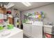 Basement laundry room with washer, dryer, and utility sink at 127 Halifax Ct, Gastonia, NC 28056