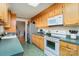 Kitchen with wood cabinets, green countertops and appliances at 127 Halifax Ct, Gastonia, NC 28056