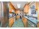 Kitchen with wood cabinets, green countertops, and appliances at 127 Halifax Ct, Gastonia, NC 28056