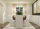 Bright dining room with a wooden table, white upholstered chairs, and natural light at 149 Dogwood Grove Pl, Troutman, NC 28166