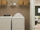 Convenient laundry room with washer, dryer, and shelving at 149 Dogwood Grove Pl, Troutman, NC 28166