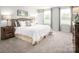 Large main bedroom with neutral carpeting and plenty of natural light at 1705 Gutter Branch Dr, Charlotte, NC 28216