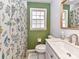 Clean bathroom with a modern vanity and a floral shower curtain at 1716 Dallas Ave, Charlotte, NC 28205