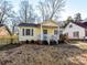 Yellow house with blue shutters and a front porch at 1716 Dallas Ave, Charlotte, NC 28205