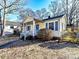 Front view of a yellow house with blue shutters and porch at 1716 Dallas Ave, Charlotte, NC 28205