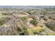 Aerial view showing property lines, a house, and surrounding wooded area with road access at 1721 Gold Hill Rd, Concord, NC 28025