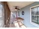 Relaxing covered porch featuring wood flooring, ceiling fans, and a serene outdoor ambiance at 1721 Gold Hill Rd, Concord, NC 28025