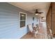 Inviting covered porch with a ceiling fan and wood flooring at 1721 Gold Hill Rd, Concord, NC 28025