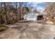 Attached two-car garage and driveway, surrounded by mature trees at 1721 Gold Hill Rd, Concord, NC 28025