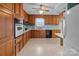 Spacious kitchen featuring wood cabinets, stainless appliances, and great countertop space at 1721 Gold Hill Rd, Concord, NC 28025