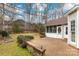 Brick patio and screened-in porch offer a nice outdoor living space in this charming backyard at 17521 Cambridge Grove Dr, Huntersville, NC 28078