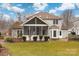 View of the home's screened-in porch and hardscape patio overlooking a large grassy lawn at 17521 Cambridge Grove Dr, Huntersville, NC 28078