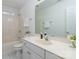 The bathroom features a clean white vanity, a large mirror, and a shower-tub combo at 17521 Cambridge Grove Dr, Huntersville, NC 28078