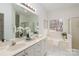 Well-lit bathroom featuring a soaking tub, double vanity, and large mirror at 17521 Cambridge Grove Dr, Huntersville, NC 28078