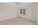 A neutral bedroom features a ceiling fan and a bright window with natural light at 17521 Cambridge Grove Dr, Huntersville, NC 28078