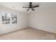 Bright bedroom with a ceiling fan and a large window providing natural light at 17521 Cambridge Grove Dr, Huntersville, NC 28078