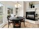 Cozy dining area with fireplace and large windows allowing natural light at 17521 Cambridge Grove Dr, Huntersville, NC 28078