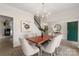 Bright dining area with a modern chandelier and views of the entryway at 17521 Cambridge Grove Dr, Huntersville, NC 28078