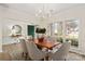 Dining area with a chandelier and large windows allowing for lots of light at 17521 Cambridge Grove Dr, Huntersville, NC 28078