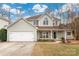 Charming two-story home with a well-manicured lawn and attached two car garage at 17521 Cambridge Grove Dr, Huntersville, NC 28078