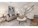 Cozy living room featuring staircase, modern decor, wood-look flooring, and natural light at 17521 Cambridge Grove Dr, Huntersville, NC 28078