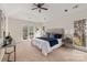 Serene bedroom with large windows, tray ceiling, and neutral decor at 17521 Cambridge Grove Dr, Huntersville, NC 28078