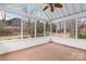 A screened porch offers a relaxing view of the outdoors with a wood-look floor at 17521 Cambridge Grove Dr, Huntersville, NC 28078