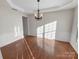 Bright dining room featuring hardwood floors and elegant chandelier at 18414 Victoria Bay Dr, Cornelius, NC 28031