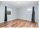 Empty bedroom with light blue walls and wood-look flooring, and windows at 1876 Rollins Dr, Catawba, NC 28609