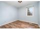 Empty bedroom with light blue walls and wood-look flooring, and one window at 1876 Rollins Dr, Catawba, NC 28609