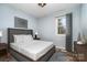 Staged bedroom with updated gray walls, dark curtains, and wood-look floors at 1876 Rollins Dr, Catawba, NC 28609