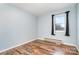 A simply decorated bedroom features a hardwood floor, a window, and neutral paint at 1876 Rollins Dr, Catawba, NC 28609