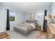 Staged bedroom with updated gray walls, dark curtains, and wood-look floors at 1876 Rollins Dr, Catawba, NC 28609