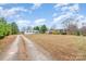 A view of a home from a long driveway reveals its rural location at 1876 Rollins Dr, Catawba, NC 28609