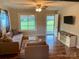 Living room features hardwood floors, large windows, and a view of the backyard at 1876 Rollins Dr, Catawba, NC 28609