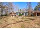 Large backyard with a sunroom featuring floor to ceiling windows along the back of the home at 1900 E Dixon Blvd, Shelby, NC 28152