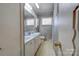 The bathroom features double sinks with tile counter, floral shower curtain and floral accents at 1900 E Dixon Blvd, Shelby, NC 28152