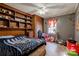 This bedroom features built-in wooden shelving and cabinets for storage, with an overhead ceiling fan at 1900 E Dixon Blvd, Shelby, NC 28152