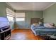 Cozy bedroom with wood floors, natural light, and a calming green color at 1900 E Dixon Blvd, Shelby, NC 28152