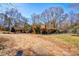 Spacious yard, perfect for outdoor activities, surrounding a brick home with mature trees at 1900 E Dixon Blvd, Shelby, NC 28152