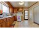 Charming kitchen with wooden cabinets, a white oven, and a window above the sink for natural light at 1900 E Dixon Blvd, Shelby, NC 28152