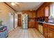 Traditional kitchen features tile flooring, wooden cabinets, and stainless steel refrigerator at 1900 E Dixon Blvd, Shelby, NC 28152