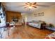 Spacious living room with a brick fireplace, hardwood floors, and a ceiling fan at 1900 E Dixon Blvd, Shelby, NC 28152