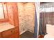 Modern bathroom with wood accents, contemporary fixtures, and a tiled walk-in shower and toilet at 198 Clouse Ln, Taylorsville, NC 28681