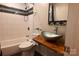 Bathroom with tub, unique glass bowl sink, decorative tile, and wood countertop at 198 Clouse Ln, Taylorsville, NC 28681