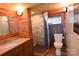 Full bathroom with wood accents, a modern sink and faucet, and walk in shower with a stone accent wall at 198 Clouse Ln, Taylorsville, NC 28681