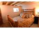 Cozy bedroom with a unique wood-frame bed and multiple pillows, illuminated by a bedside lamp for a warm ambiance at 198 Clouse Ln, Taylorsville, NC 28681