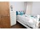Bedroom with a twin bed, white dresser, and simple decor next to closet at 198 Clouse Ln, Taylorsville, NC 28681