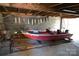 Red fishing boat and kayaks stored in a spacious garage at 198 Clouse Ln, Taylorsville, NC 28681