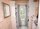 Custom closet with white shelving, wood panelling, view to outdoor deck and decorative tile floor at 198 Clouse Ln, Taylorsville, NC 28681